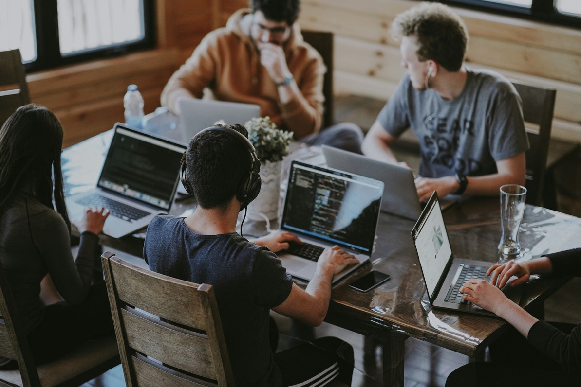 Professional using AI tools on a computer while demonstrating strong work ethic in a modern workplace.
